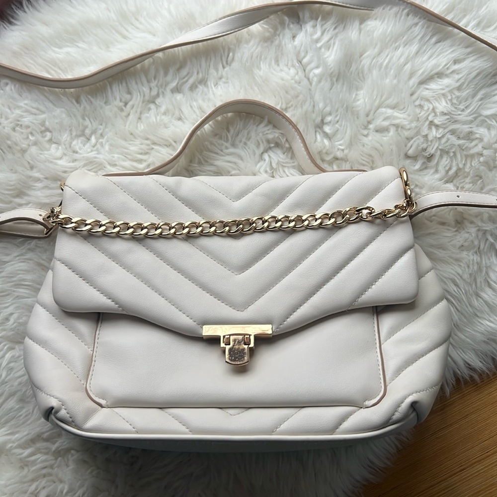 White purse with gold chain and clasp